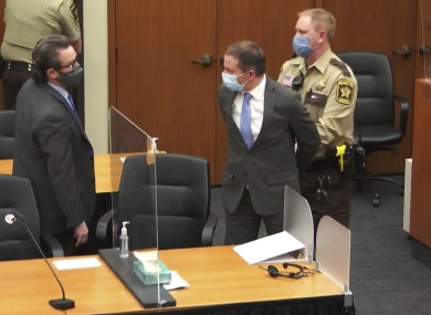 Former Minneapolis police Officer Derek Chauvin is taken into custody as his attorney, Eric Nelson, left, looks on
