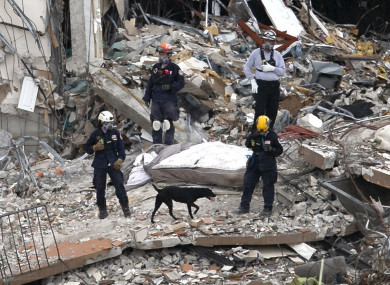 South Florida Urban Search and Rescue team look through rubble for survivors at the partially collapsed Champlain Towers South condo building