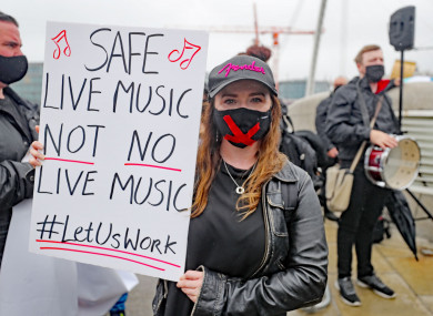 Musician and singer Jenny O’Donovan joins a protest outside the Convention Centre in Dublin, calling for a loosening of coronavirus restrictions.
