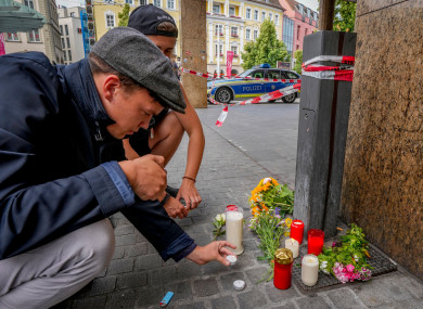 Flowers and candles are laid at the scene of the stabbings in central Wuerzburg