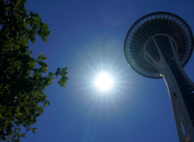 The sun shines near the Space Needle, Monday, June 28, 2021, in Seattle.