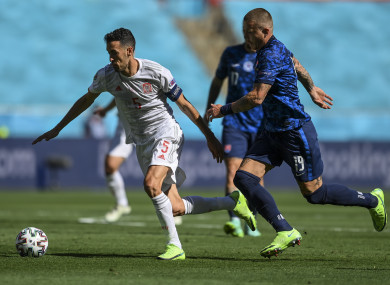 Spain's Sergio Busquets, left, duels for the ball with Slovakia's Juraj Kucka.