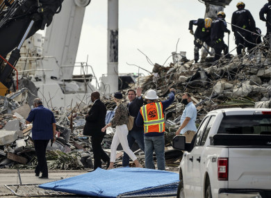 Gov Ron DeSantis tours the site of the rubble while people pass through the memorial wall to pay their respects.