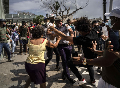 Violence breaks out as Cuban police attempt to arrest an anti-government protestor.