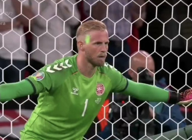 A laser pointer is directed towards Kasper Schmeichel from the stands.