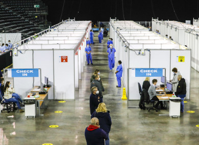 People queuing to receive the vaccine at the Covid-19 vaccination centre in the SSE Arena, Belfast (Liam McBurney/PA)