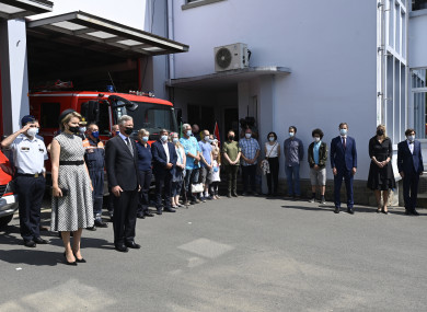 Belgium's King Philippe and Queen Mathilde stand with victims and emergency workers during one minute of silence.