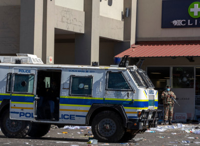 Soldiers patrol and police at a shopping centre in Soweto
