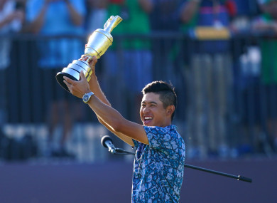 Collin Morikawa celebrates with the Claret Jug.