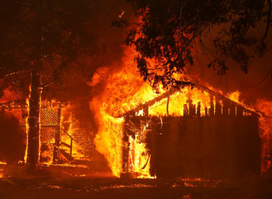 A house is fully engulfed by flames at the Dixie Fire last week.