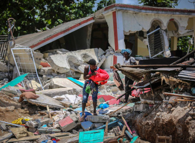 People recover belongings from their homes destroyed in the earthquake in Camp-Perrin, Les Cayes, Haiti.