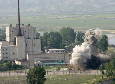 The cooling tower of the Yongbyon nuclear complex being demolished in North Korea in 2008.