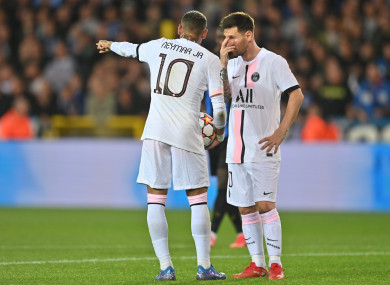 PSG's Neymar Jr. and PSG's Lionel Messi talk during a game.