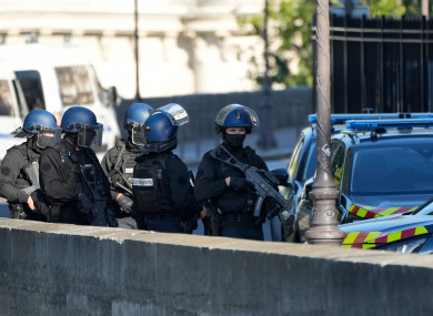 Security forces patrol outside the Palais de Justice in Paris.