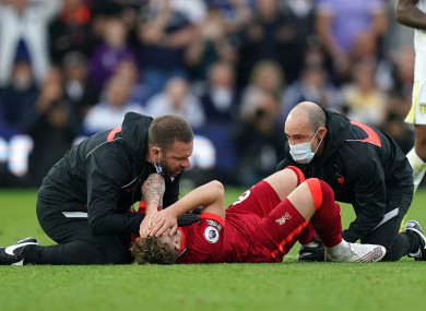 Liverpool's Harvey Elliott receives treatment after picking up a bad injury.