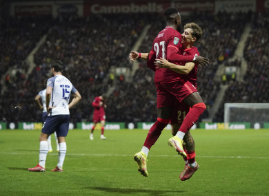 Origi celebrates with Kostas Tsimikas.