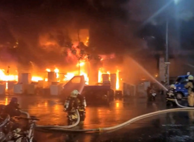 In this image taken from video by Taiwan’s EBC, firefighters battle a blaze at a building in Kaohsiung, in southern Taiwan