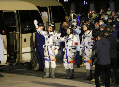 From left, Chinese astronauts Zhai Zhigang, Wang Yaping, and Ye Guangfu, wave before leaving for the Shenzhou-13 crewed space mission at the Jiuquan Satellite Launch Centre in northwest China
