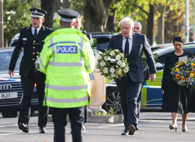Essex Police chief Ben-Julian Harrington, Labour leader Keir Starmer, Prime Minister Boris Johnson and Home Secretary Priti Patel carry flowers as they arrive at the scene in Leigh-on-Sea where MP David Amess died