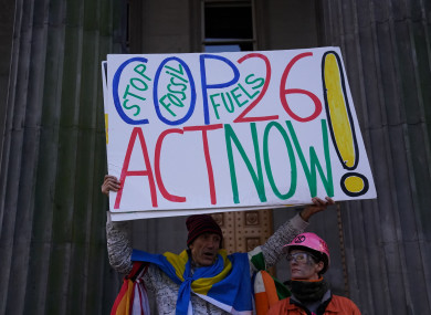 A climate activist holds up a placard in Glasgow