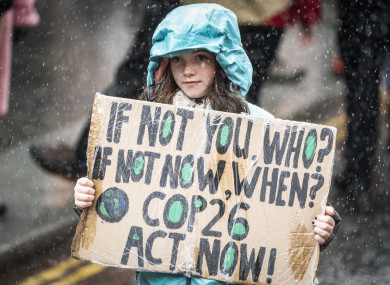 A protester holds up a sign on a climate rally in Glasgow
