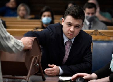 Kyle Rittenhouse pulls numbers of jurors out of a tumbler during his trial at the Kenosha County Courthouse in Kenosha
