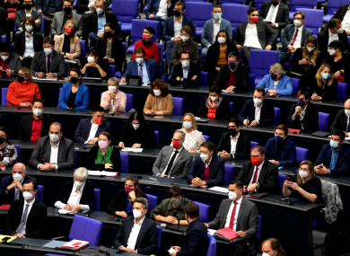 Lawmakers wear face mask as they attend a Bundestag session.