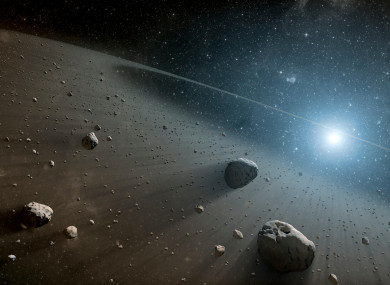 his artist's concept illustrates an asteroid belt around the bright star Vega.