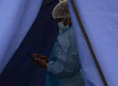 A healthcare worker waits to test people for Covid-19 at a facility in Soweto, South Africa,