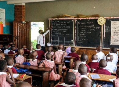Pupils wear face masks as they attend class at Kitante Primary School in Kampala, Uganda