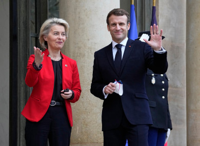 French President Emmanuel Macron waves as he greets European Commission president Ursula von der Leyen at the Elysee Palace in Paris