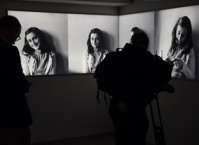 A journalist takes images of pictures of Anne Frank at the renovated Anne Frank House Museum in Amsterdam, Netherlands.