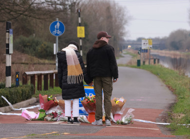 Locals pay tribute at the scene of the attack yesterday.