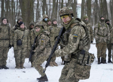 Members of Ukraine's Territorial Defense Forces, volunteer military units of the Armed Forces, train in a city park in Kyiv.