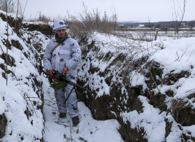 A serviceman stands in a trench on territory controlled by pro-Russian militants at the frontline in Luhansk region.