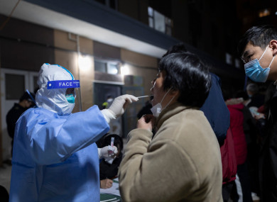 A woman gets her throat swabbed in Shanghai as part of China’s ‘zero tolerance’ strategy (AP)