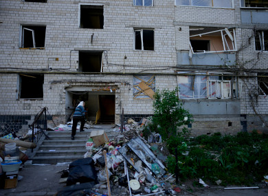 A resident enters her home building ruined by shelling in Borodyanka, Ukraine.