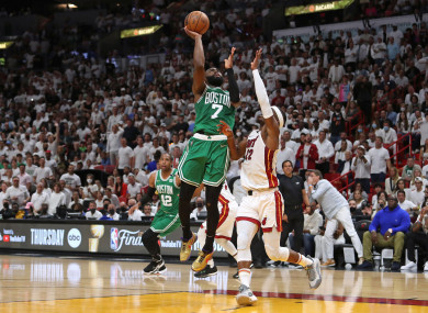 Boston Celtics forward Jaylen Brown shoots over Miami Heat forward Jimmy Butler.