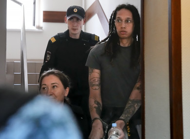 WNBA star and two-time Olympic gold medalist Brittney Griner is escorted to a courtroom for a hearing, in Khimki just outside Moscow.