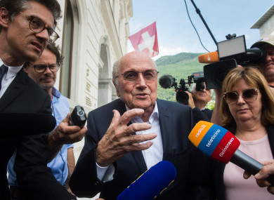 Former FIFA president Sepp Blatter is surrounded by the media as he leaves the Swiss Federal Criminal Court in Bellinzona.