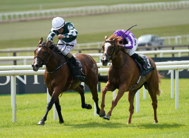 Magical Lagoon, ridden by Shane Foley (left), on their way to winning the Juddmonte Irish Oaks.