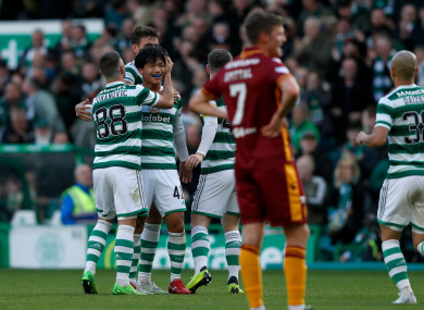Reo Hatate celebrates with teammates after scoring Celtic's second goal.