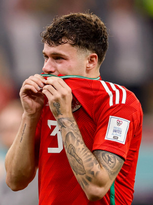 Wales' Neco Williams cries after the game.