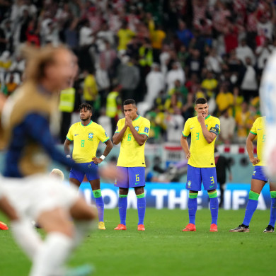 Brazil's Alex Sandro and Thiago Silva watch on as Croatia's players celebrate.