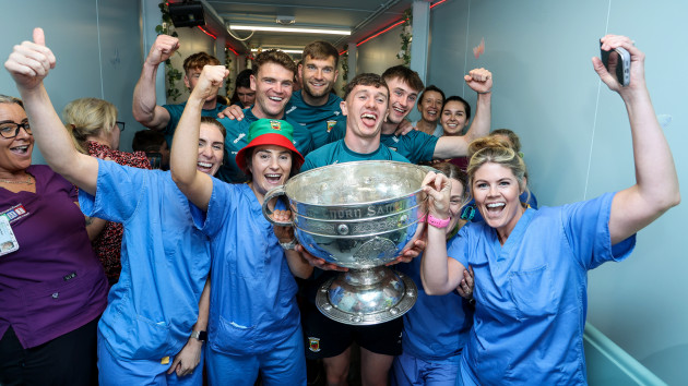 It brings great joy to the hospital: All-Ireland champions Mayo visit patients at Temple Street Dozens gathered outside the childrens hospital today, where the young team lifted the Sam Maguire before visiting staff and patients.